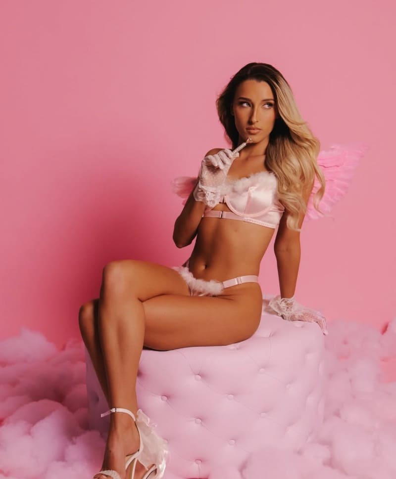 Maya on chair with pink lingerie