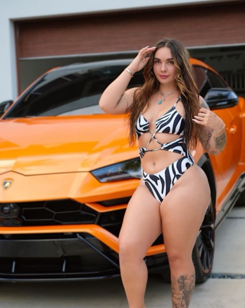 Abby in front of lamborghini