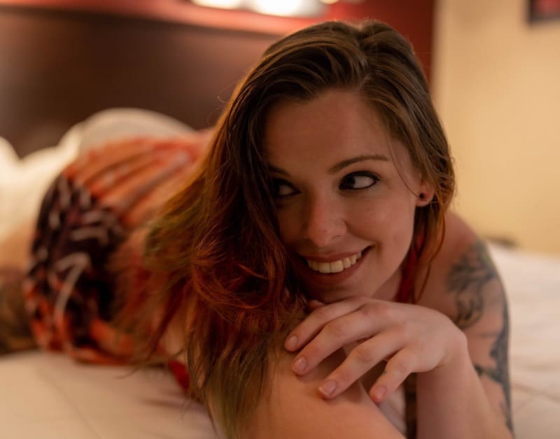 Kels on bed in orange