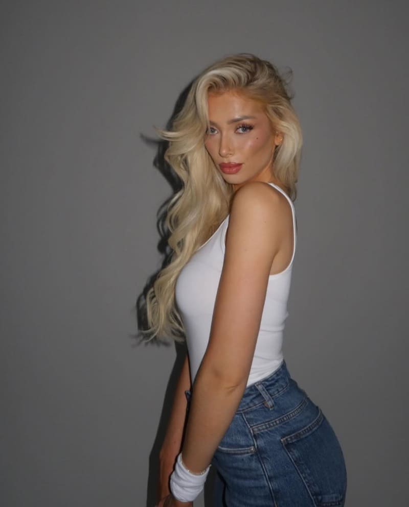 Maria in jeans and white top