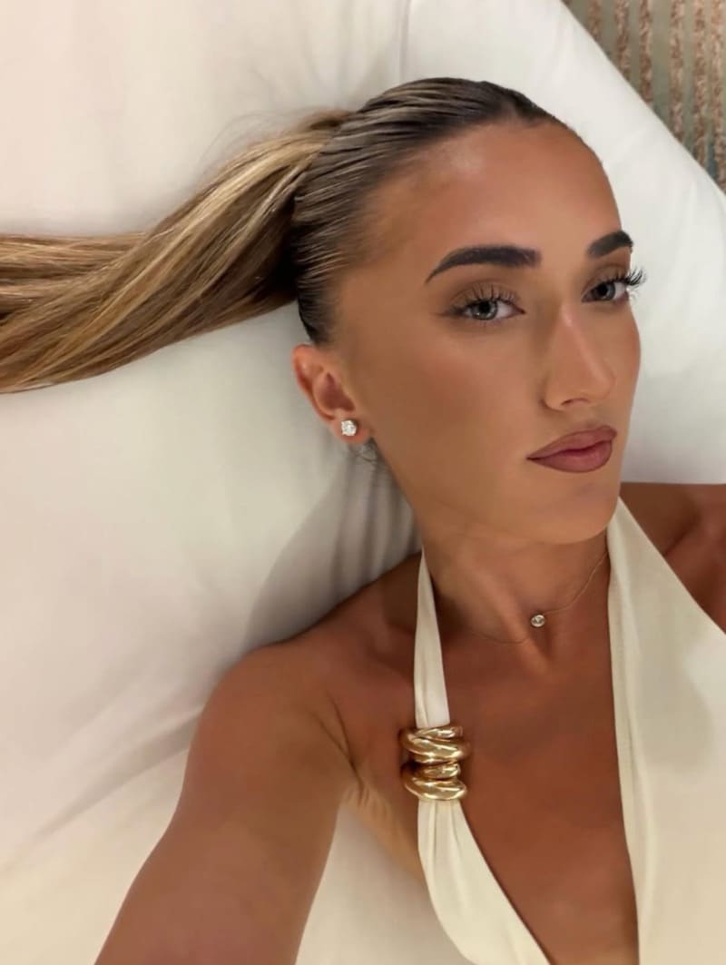 Sexy blonde onbed in white dress