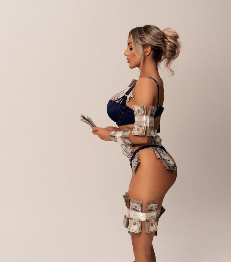 Sexy model in lingerie with money on body