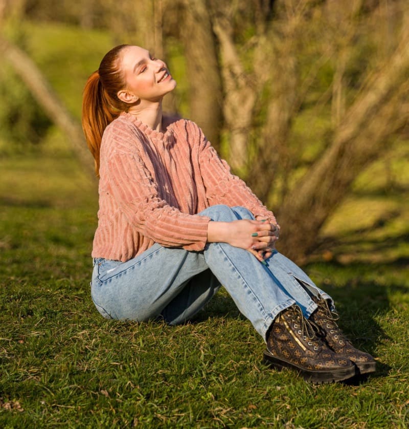 Hot babe in jeans on grass