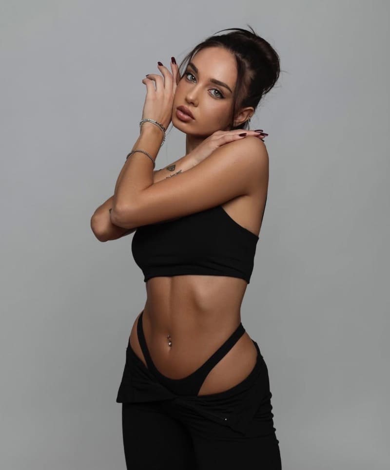 Hot model in tight black outfit with low jeans