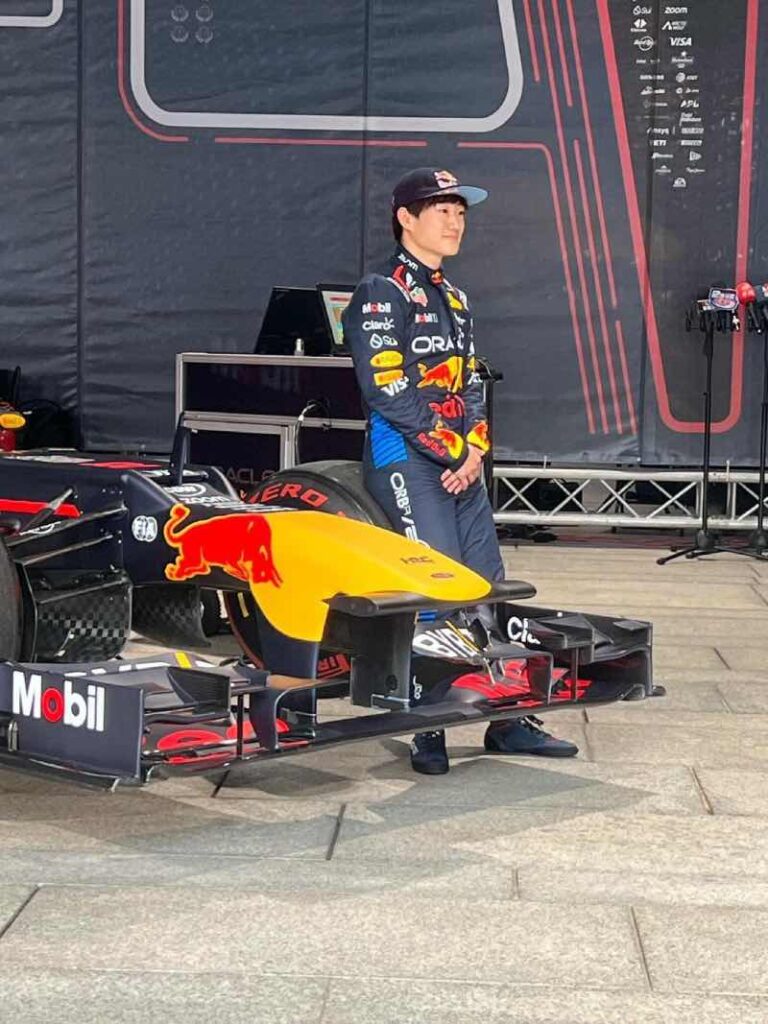 Yuki Tsunoda naast Red Bull wagen
